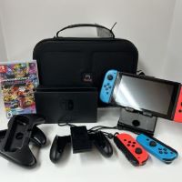 Nintendo switch with carrying case, two red controllers, two blue controllers, tabletop stand, tv dock, multi-player grip, single player grip and mariokart 8 game