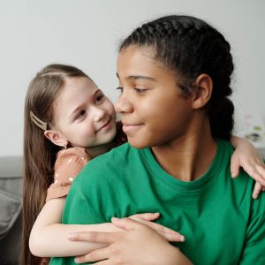 diverse siblings hugging