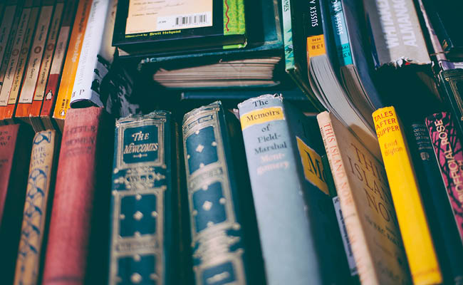 Close-up view of assorted book spines on a shelf.