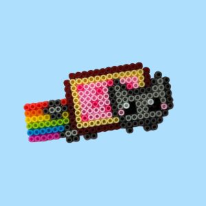 Pixel art of a cat with a Pop-Tart body and a trailing rainbow, made from colorful beads on a blue background.